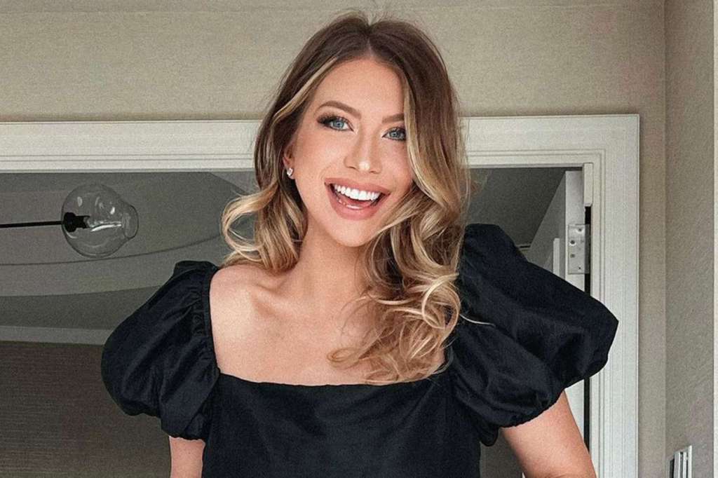 Pump Rules alum Stassi Schroeder smiles in puffy sleeve black dress