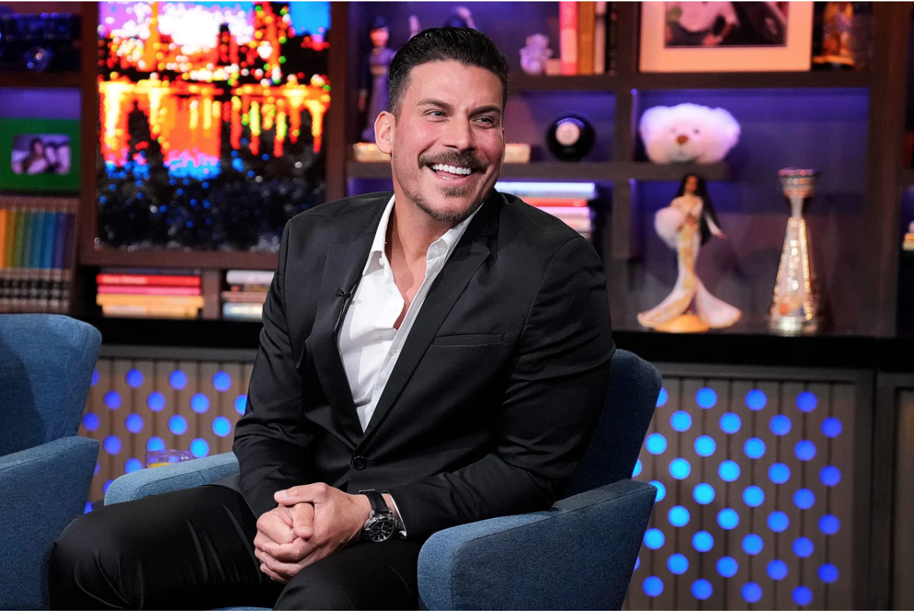 Vanderpump Rules alum Jax Taylor laughs while appearing on WWHL
