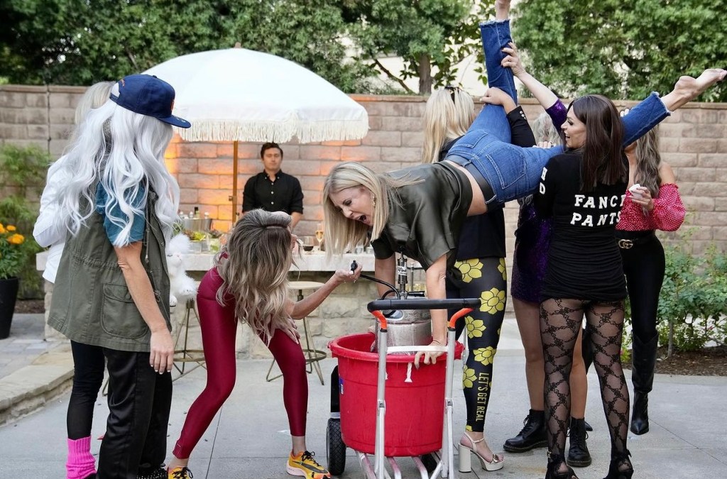 Vicki Gunvalson drinking from a keg with the group on The Real Housewives of Orange County Season 17 Episode 10.