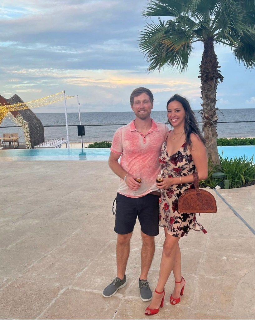 Vanderpump Rules OG Kristen Doute poses for photo with boyfriend Luke Broderick in front of the pool and ocean at Dreams Natura Resort & Spa in Cancún