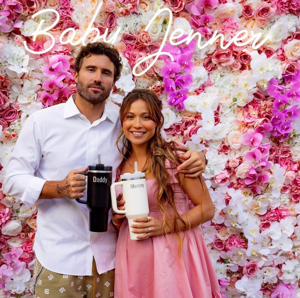 The Hills alum Brody Jenner poses for photo with fiancée Tia Blanco in front of floral wall at baby shower