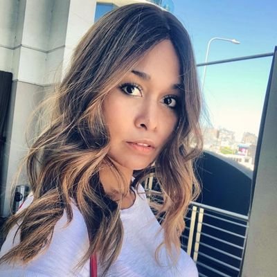 RHOP alum Katie Rost poses for selfie in white t-shirt with tousled wavy hair